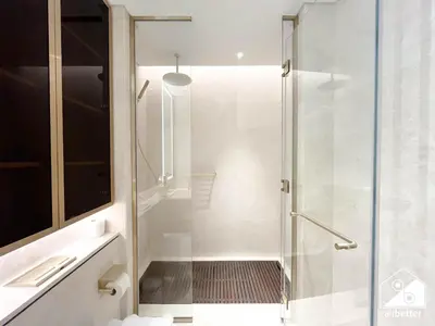 a shower with a glass door in a bathroom at Luxury Beachfront 1BR on Palm Jumeirah & Balcony in Dubai