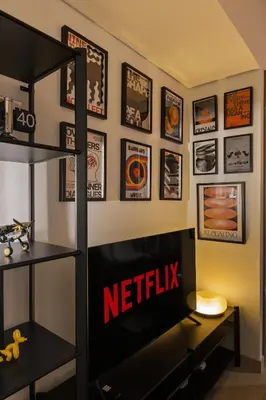 a tv in a room with a netflix sign on a wall at Elite Escapes - Boy Girl Apartment Edition in Dubai