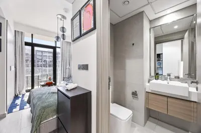 a bathroom with a bed and a sink and a toilet at Elite Escapes - Boy Girl Apartment Edition in Dubai