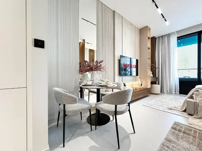 a dining room with a table and chairs at Peaceful Studio Stay Canal Views Poolside Comfort in Dubai