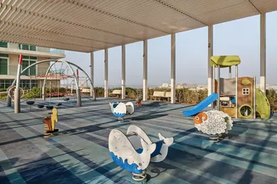 a childrens playground with slides and rides in a building at 4BR Beachfront Marina & Palm View in Dubai
