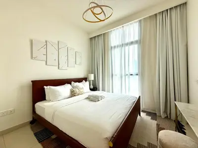 a bedroom with a large bed and a large window at Cozy 1BR Burj Crown Downtown in Dubai