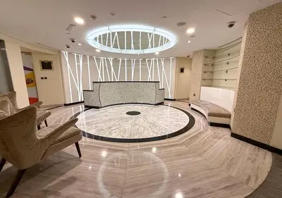 a living room with a glass table and a couch at Capital Bay city view Studio in Dubai