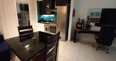 a kitchen with a counter and a desk in a kitchen at Capital Bay city view Studio in Dubai