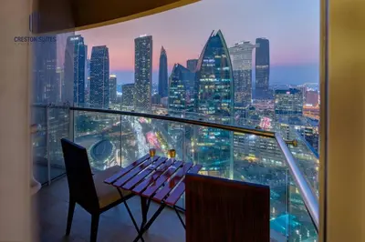 a balcony with a table and chairs and a city skyline at Exclusive 1BDR Near Burj Khalifa with Free Parking in Dubai