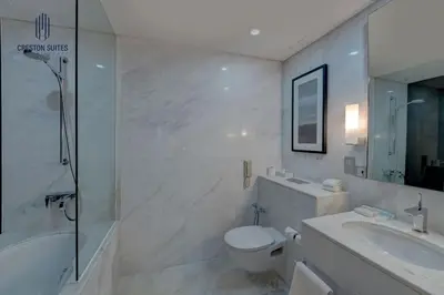 a bathroom with a tub and a toilet and a sink at Exclusive 1BDR Near Burj Khalifa with Free Parking in Dubai