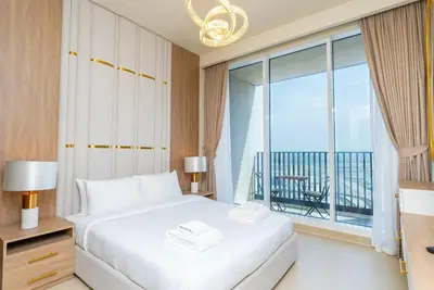 a bedroom with a white bed and a large window at On the dock Nice 1bedroom in Dubai Creek Harbour in Dubai