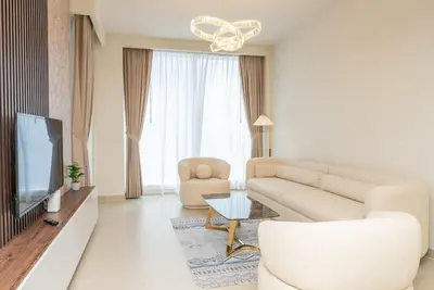 a living room with a couch and a tv at On the dock Nice 1bedroom in Dubai Creek Harbour in Dubai