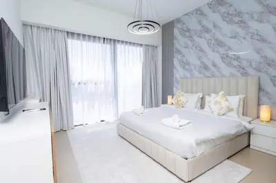 a bedroom with a bed and a large window at Downtown Escape 2bedroom Apartment 4 guests Dubai in Dubai