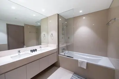 a bathroom with two sinks and a tub and a large mirror at Downtown Escape 2bedroom Apartment 4 guests Dubai in Dubai
