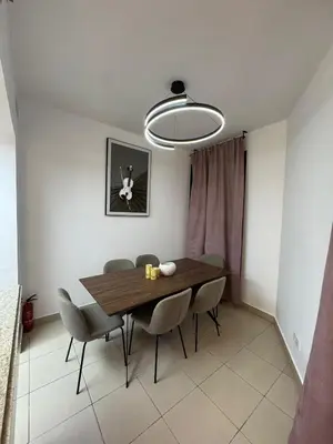 a dining room with a wooden table and chairs at Apartments on Marina in Dubai