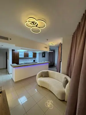a living room with a couch and a kitchen at Apartments on Marina in Dubai
