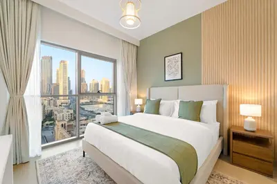 a bedroom with a large bed and a large window at Elegant 3-Bedroom Apartment - Panoramic Burj Khalifa and Downtown Views in Dubai