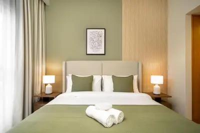 a bedroom with a bed with two towels on it at Elegant 3-Bedroom Apartment - Panoramic Burj Khalifa and Downtown Views in Dubai