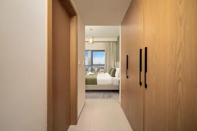 a hallway leading to a bedroom with a bed at Elegant 3-Bedroom Apartment - Panoramic Burj Khalifa and Downtown Views in Dubai