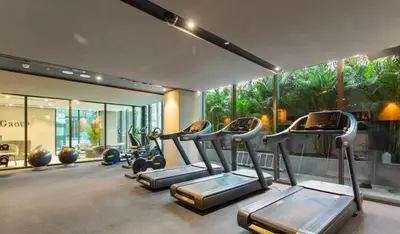 a gym with cardio equipment in a building at Modern Studio Near Burj Khalifa & Dubai Mall with Pool, Gym, Concierge & Parking in Dubai