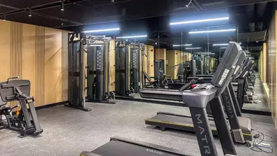 a gym with a treadmill and other equipment in it at Modern Studio in JVC, Rooftop Pool & Gym Access - 10AB08 in Dubai