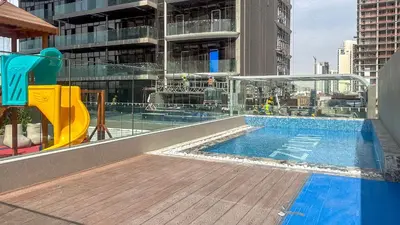 a swimming pool on the roof of a building at Modern Studio in JVC, Rooftop Pool & Gym Access - 10AB08 in Dubai