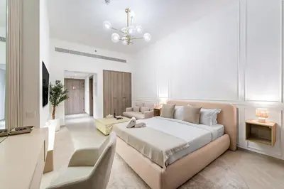 a large white bedroom with a large bed and a couch at FIRST CLASS Studio Luxe & Cozy Vibes in Dubai