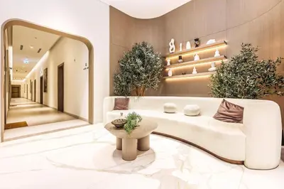 a living room with a white couch and a table at FIRST CLASS Studio Luxe & Cozy Vibes in Dubai