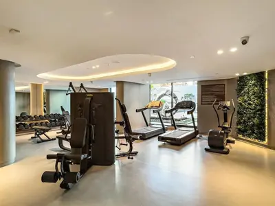 a gym with treadmills and exercise equipment in a room at FIRST CLASS Studio Luxe & Cozy Vibes in Dubai