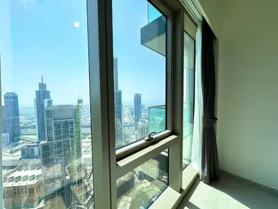 a window with a view of a city at Grande Signature Burj Khalifa view 4 Min walk Dubai Mall Infinity Pool with Fountain View Free parking By The Meridian in Dubai