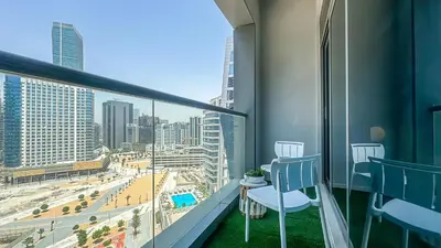 a balcony with chairs and a view of a city at Cozy Studio with Balcony Overlooking Dubai Canal - 15AB07 in Dubai