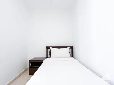 a bed in a white room with a pillow on it at Stunning 4 bedroom with Breathtaking Sea View JBR in Dubai