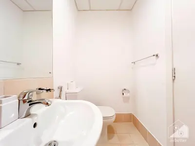 a white bathroom with a toilet and a sink at Stunning 4 bedroom with Breathtaking Sea View JBR in Dubai