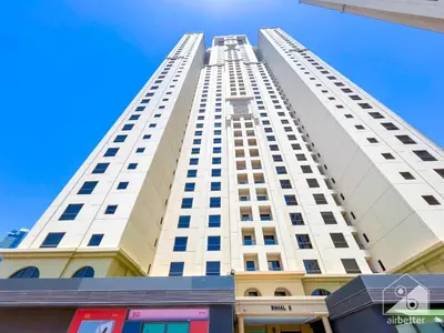 a tall white building with a blue sky in the background at Stunning 4 bedroom with Breathtaking Sea View JBR in Dubai