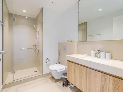 a bathroom with a toilet and a sink and a shower at TRPS - Downtown Views II Tower 2, Downtown Dubai - 3BR plus Maids - Stylish Apartment Near Burj Khalifa & Attractions in Dubai