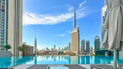 a view of a city skyline from a pool at TRPS - Downtown Views II Tower 2, Downtown Dubai - 3BR plus Maids - Stylish Apartment Near Burj Khalifa & Attractions in Dubai