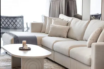 a living room with a white couch and a table at SkyHigh Stay, Panoramic Sea Views & Beach Access in Dubai