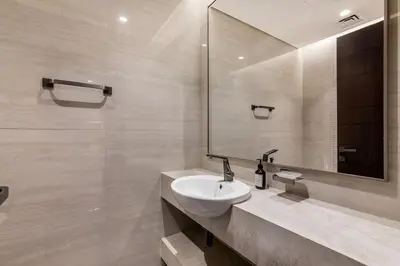 a bathroom with a sink and a mirror at Nobles Tower tiger one skyline view in Dubai