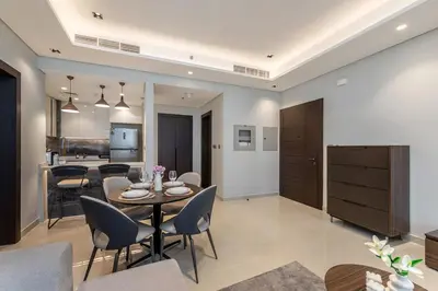 a dining room and living room with a table and chairs at Nobles Tower tiger one skyline view in Dubai