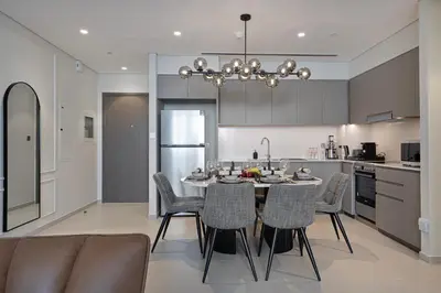 a kitchen and dining room with a table and chairs at Luxury 2BR Sea View Walk to Burj & Dubai Mall in Dubai