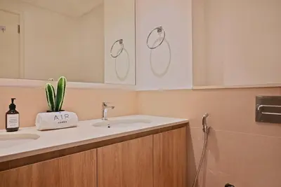 a bathroom with a sink and a plant on the counter at Air Homes - Stylish 2BR Near Dubai Hills Mall & Park in Dubai