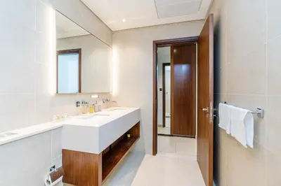 a bathroom with a white sink and a mirror at Contemporary Comfort - Serenity - Pool View in Dubai