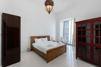 a bedroom with a bed and a red cabinet at Cayan Tower Dubai Marina - Mint Stay in Dubai