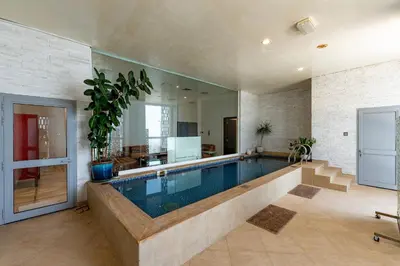 a large swimming pool in a house at Cayan Tower Dubai Marina - Mint Stay in Dubai