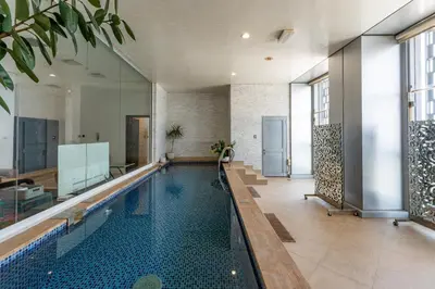 a swimming pool in a building with a house at Cayan Tower Dubai Marina - Mint Stay in Dubai