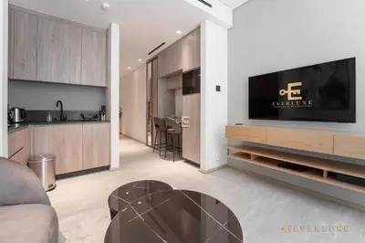 a living room with a television on a wall at Contemporary Studio Terrace Luxe & Secure Stay in Dubai