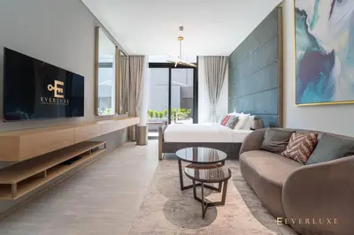 a living room with a couch and a tv at Contemporary Studio Terrace Luxe & Secure Stay in Dubai