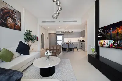 a living room with a couch and a table at Luxury2BR Sea View Hot Tub Walk to Burj Dubai Mall in Dubai