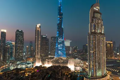 a city skyline at night with a tall building at Stunning 3BR Burj Fountain view & Dubai Mall in Dubai