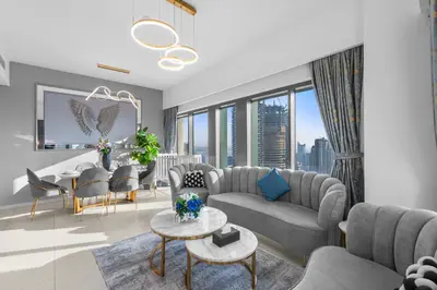 a living room with a couch and chairs and a table at Stunning 3BR Burj Fountain view & Dubai Mall in Dubai