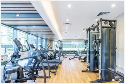 a gym with cardio machines and treadmills at Modern 1BR in Business Bay - Balcony with Skyline Views in Dubai