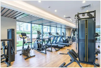 a gym with treadmills and cardio equipment in a building at Modern 1BR in Business Bay - Balcony with Skyline Views in Dubai