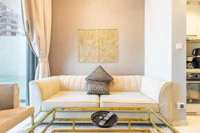 a living room with a couch and a table at Modern 1BR in Business Bay - Balcony with Skyline Views in Dubai