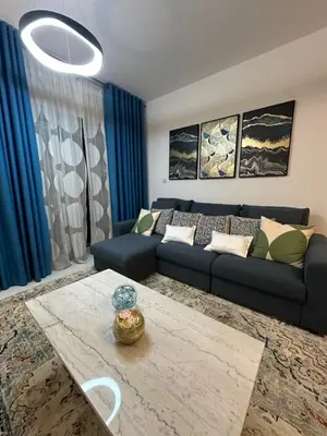 a living room with a couch and a table at C Infinity Holiday Homes in Dubai Marina in Dubai